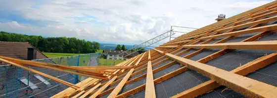 The photo shows a roof being newly covered