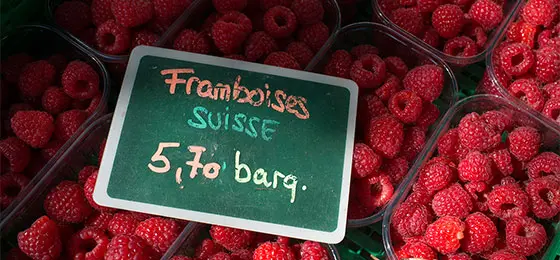 Prepacked raspberries on a Swiss market stall