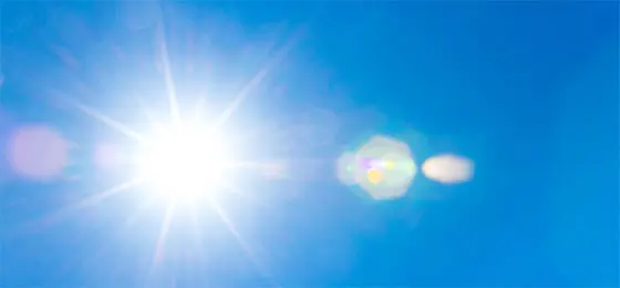 The image shows the sun in a blue summer sky.