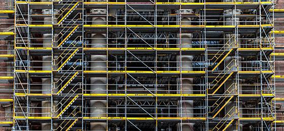 The picture shows a building behind a scaffold.