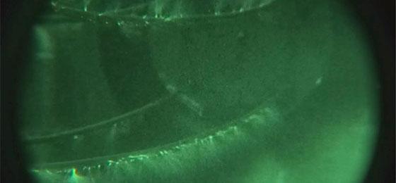 The image shows the so-called corona effect of a high-voltage power line in the laboratory